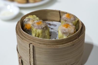 High angle view of dim sum in container on white background