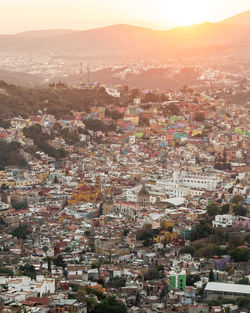 High angle shot of townscape against sky at sunset