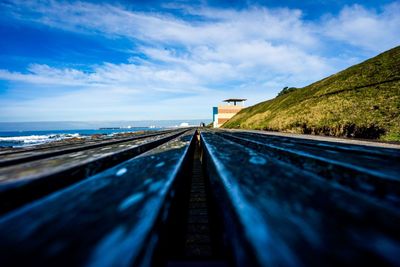 Surface level of road against blue sky