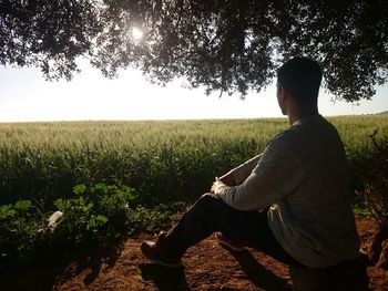 Rear view of a man in field