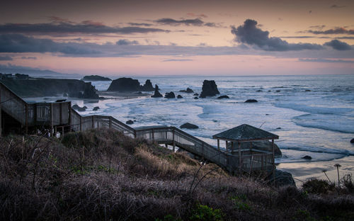 Stairs going down to the beach in bandon, oregon. moody winter photo