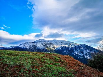 Scenic view of mountains against blue sky