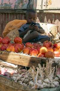 High angle view of boy sitting at market stall