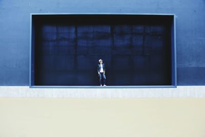 Woman standing in front of industrial building