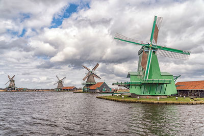 Traditional windmill against cloudy sky