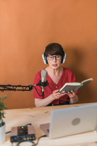 Woman podcasting at studio