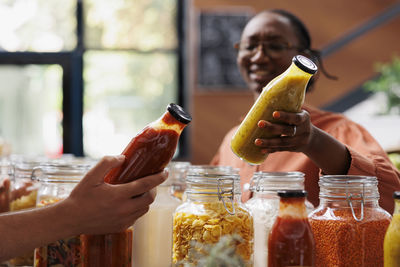 Midsection of woman holding drink