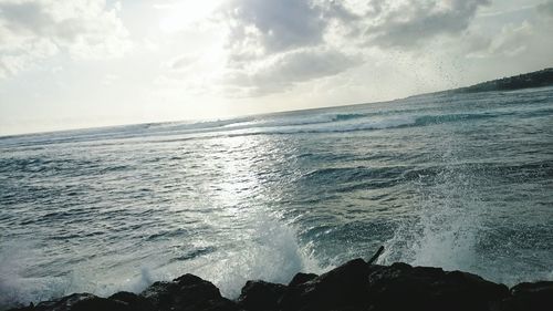 Scenic view of sea against cloudy sky