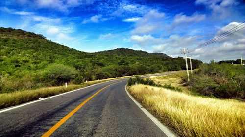 Empty road with mountains in background