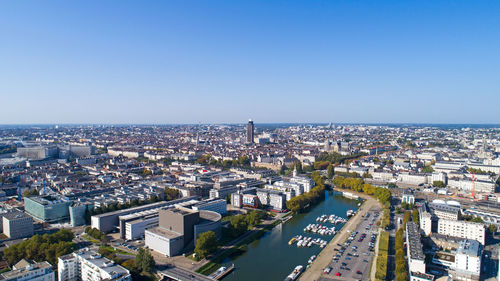 High angle view of cityscape against clear blue sky