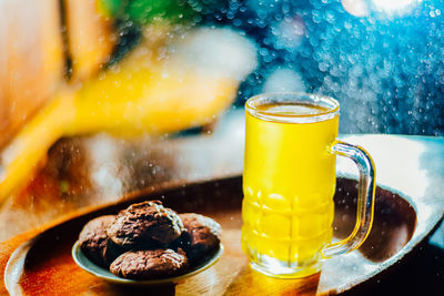 Chinese chrysanthemum tea in tall glass and brownie cookies on festive new year background