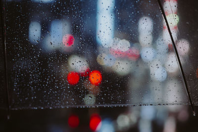 Close-up of wet glass window during rainy season