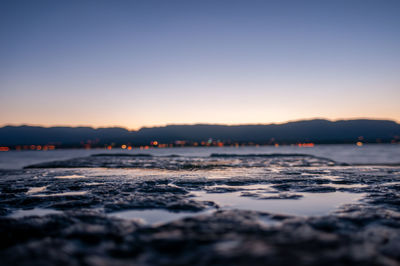 Scenic view of sea against clear sky at sunset