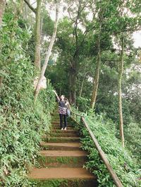 Woman on staircase in forest