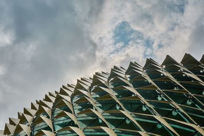 Low angle view of building against cloudy sky