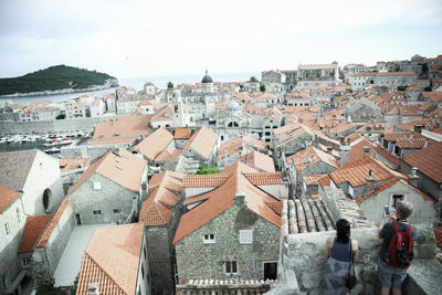 High angle view of houses in town against sky