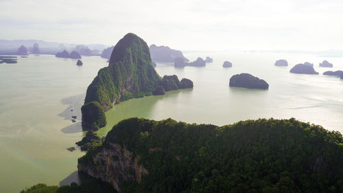 Rock formations in sea against sky