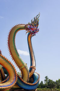  low angle twin stucco painted as a large serpent at pra kai keaw wang nakin, udon thani, thailand. 