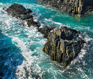 High angle view of rocks in sea