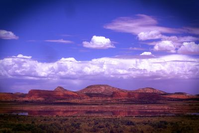 Scenic view of mountains against cloudy sky