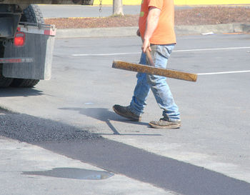 Low section of man working on road