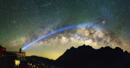 Panoramic view of trees against sky at night