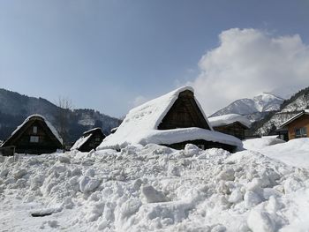 Snow covered house against sky shirakawago village
