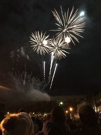 Low angle view of firework display at night