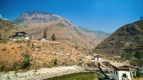 Scenic view of mountains against blue sky