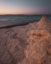 Scenic view of sea against clear sky during sunset