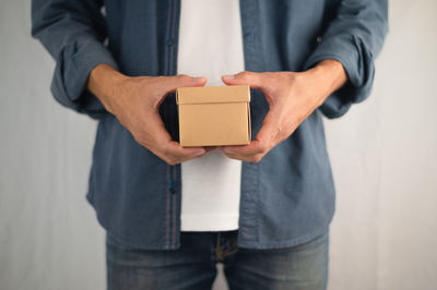 Midsection of man standing on paper