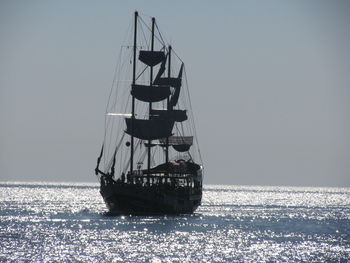 Ship sailing in sea against sky