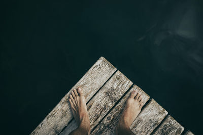 Man standing on wooden jetty over monticolo lake