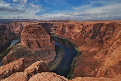 Scenic view of rock formations against cloudy sky