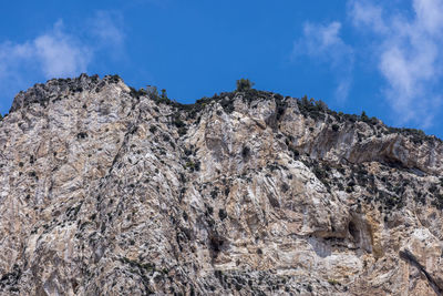 Low angle view of rock formation against sky