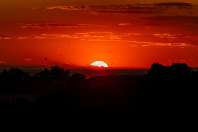 Scenic view of silhouette landscape against romantic sky at sunset
