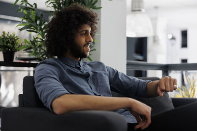 Young man sitting on chair