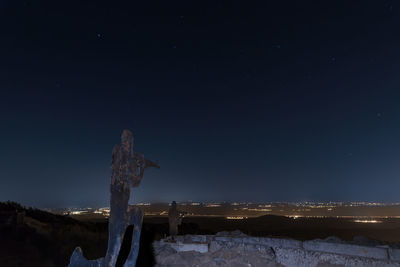 Scenic view of snowcapped mountains against sky at night