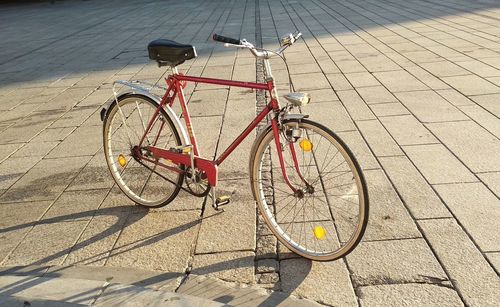 High angle view of bicycle parked on footpath