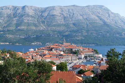 High angle view of townscape by sea