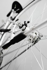Low angle view of bicycle wheel against white background