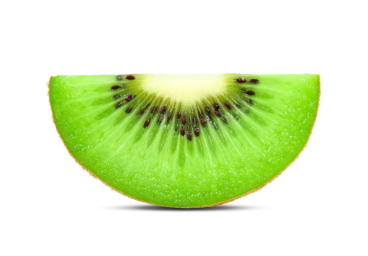 CLOSE-UP OF GREEN FRUIT AGAINST WHITE BACKGROUND