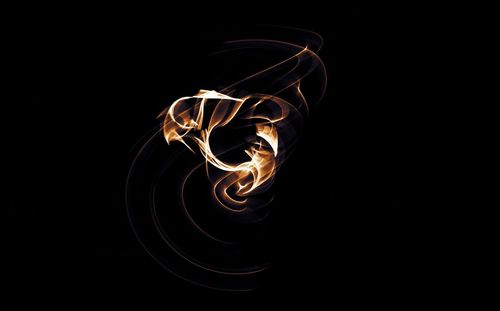 Fire and light painting against black background