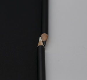 Close-up of pencils on table against white background