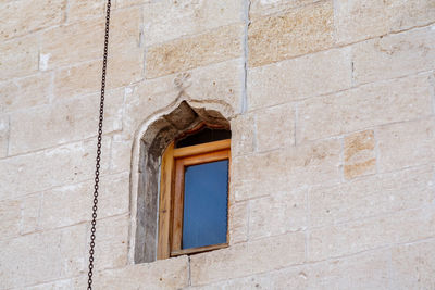 Low angle view of window on wall of building