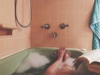 Low section of woman in bathtub