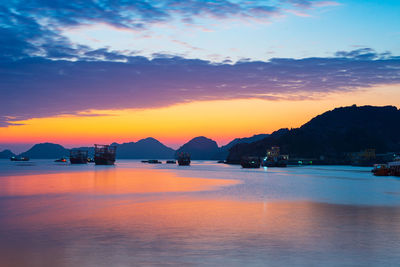 Scenic view of sea against romantic sky at sunset