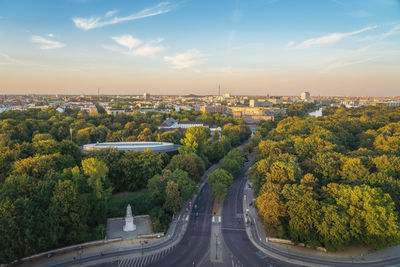 High angle view of road amidst buildings against sky during sunset