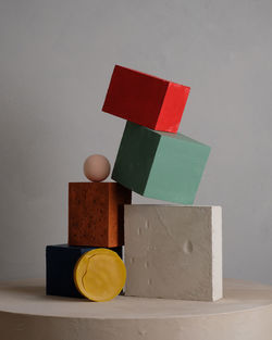 Close-up of toys on table against wall