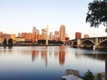 Bridge over mississippi river by buildings against clear sky